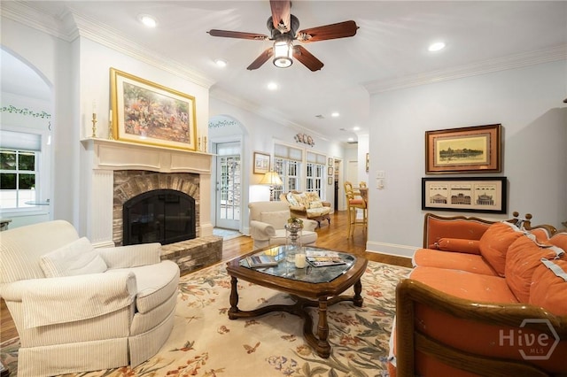 10 Cedar View Dr, Savannah, GA 31410 - living room featuring arched walkways, wood finished floors, ceiling fan, a fireplace, and crown molding