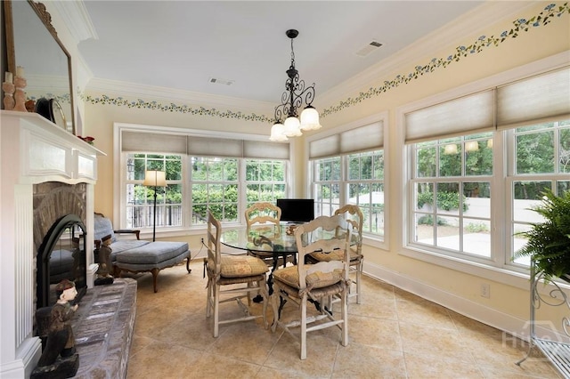 10 Cedar View Dr, Savannah, GA 31410 - dining area with ornamental molding, light tile patterned flooring, a glass covered fireplace, and baseboards