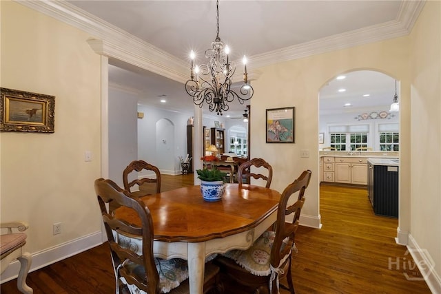 10 Cedar View Dr, Savannah, GA 31410 - dining area featuring arched walkways, a chandelier, dark wood finished floors, and crown molding