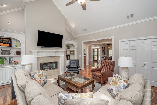 14 Black Hawk Trl, Savannah, GA 31411 - living area featuring built in shelves, wood finished floors, ceiling fan, ornamental molding, and a fireplace
