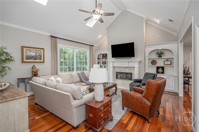 14 Black Hawk Trl, Savannah, GA 31411 - living area featuring ceiling fan, a high end fireplace, wood finished floors, a skylight, and vaulted ceiling
