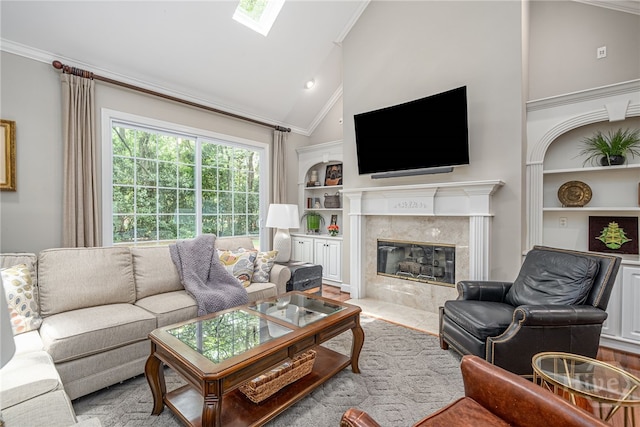 14 Black Hawk Trl, Savannah, GA 31411 - living area with crown molding, built in shelves, a tiled fireplace, a skylight, and high vaulted ceiling