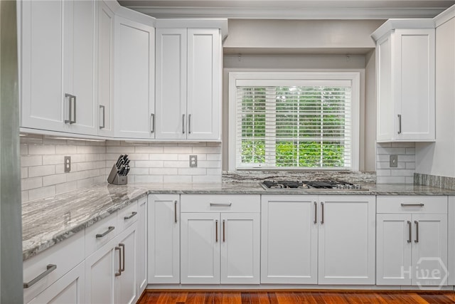 14 Black Hawk Trl, Savannah, GA 31411 - kitchen with gas cooktop, backsplash, white cabinetry, and light stone countertops