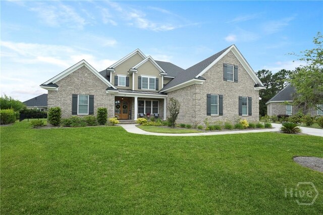15 Reed Grass Ln, Savannah, GA 31405 - view of front of house featuring brick siding, covered porch, and a front lawn