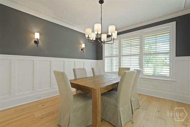15 Reed Grass Ln, Savannah, GA 31405 - dining area with a decorative wall, light wood finished floors, a chandelier, crown molding, and a wainscoted wall