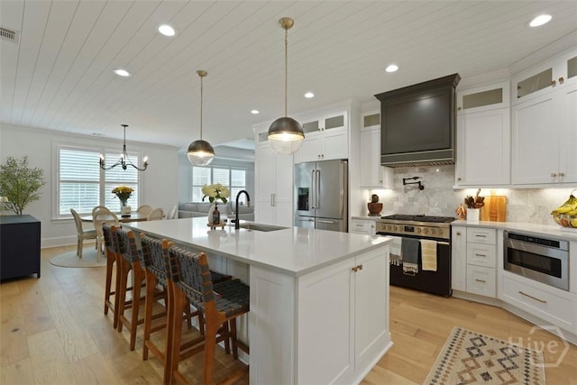 15 Reed Grass Ln, Savannah, GA 31405 - kitchen with stainless steel appliances, a sink, light wood-type flooring, light countertops, and tasteful backsplash