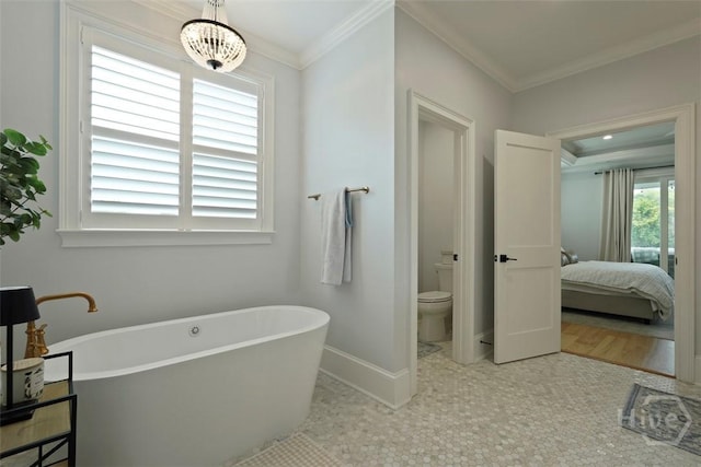 15 Reed Grass Ln, Savannah, GA 31405 - ensuite bathroom with a soaking tub, toilet, crown molding, and baseboards