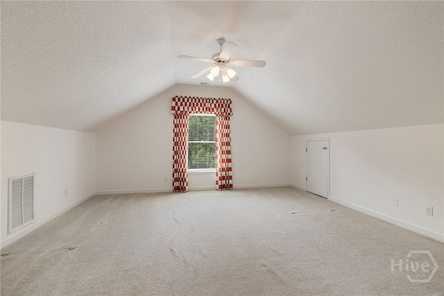 35 Wild Thistle Ln, Savannah, GA 31406 - additional living space with a textured ceiling, light carpet, ceiling fan, lofted ceiling, and baseboards