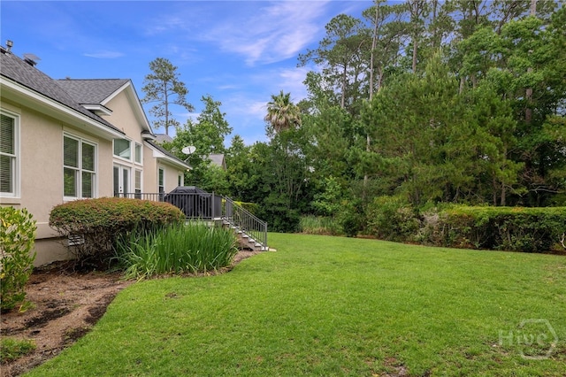 35 Wild Thistle Ln, Savannah, GA 31406 - view of green lawn featuring stairway and a wooden deck
