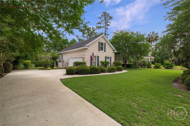 35 Wild Thistle Ln, Savannah, GA 31406 - traditional-style house featuring driveway, stucco siding, and a front lawn