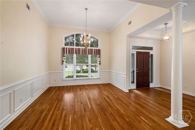 35 Wild Thistle Ln, Savannah, GA 31406 - unfurnished dining area with ornate columns, ornamental molding, wood finished floors, a decorative wall, and a wainscoted wall