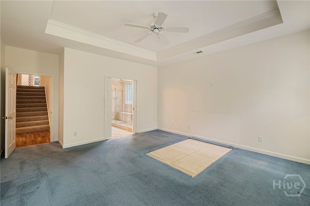 35 Wild Thistle Ln, Savannah, GA 31406 - carpeted empty room with a raised ceiling, ornamental molding, stairs, baseboards, and ceiling fan