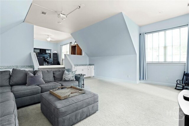 711 Chastain Cir, Richmond Hill, GA 31324 - living area with lofted ceiling, light colored carpet, baseboards, and ceiling fan