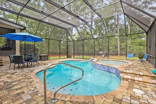 711 Chastain Cir, Richmond Hill, GA 31324 - view of swimming pool featuring a patio area, a pool with connected hot tub, and glass enclosure