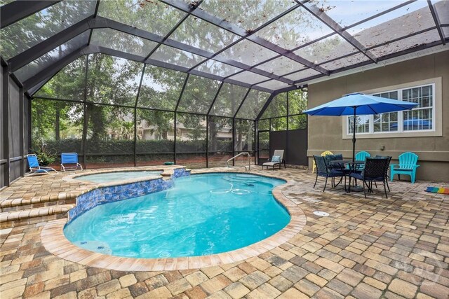 711 Chastain Cir, Richmond Hill, GA 31324 - view of pool with a patio area, glass enclosure, and a pool with connected hot tub