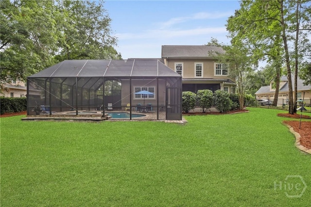 711 Chastain Cir, Richmond Hill, GA 31324 - rear view of property with a lawn, a pool with connected hot tub, a patio, and a lanai