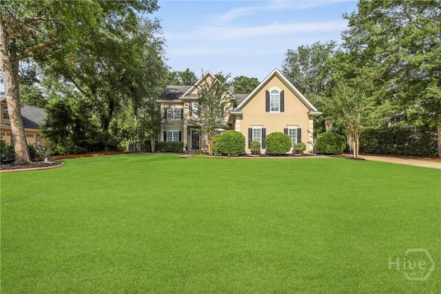 711 Chastain Cir, Richmond Hill, GA 31324 - view of front of property with a front yard and stucco siding