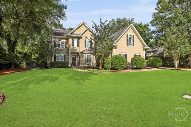 711 Chastain Cir, Richmond Hill, GA 31324 - traditional home with a front lawn and stucco siding