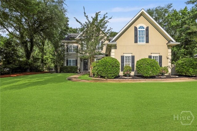 711 Chastain Cir, Richmond Hill, GA 31324 - view of front of home featuring a front lawn and stucco siding
