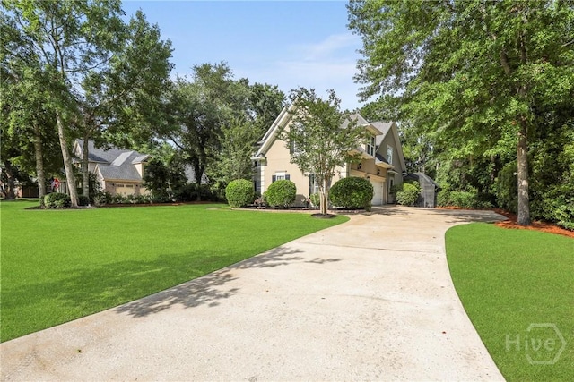 711 Chastain Cir, Richmond Hill, GA 31324 - view of front of home with driveway, a front lawn, a garage, and stucco siding