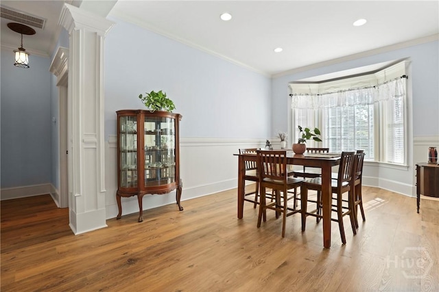 711 Chastain Cir, Richmond Hill, GA 31324 - dining space featuring ornamental molding, ornate columns, light wood-style flooring, wainscoting, and recessed lighting