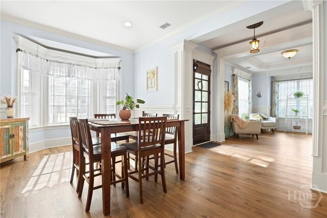 711 Chastain Cir, Richmond Hill, GA 31324 - dining area featuring crown molding, wood finished floors, decorative columns, and baseboards