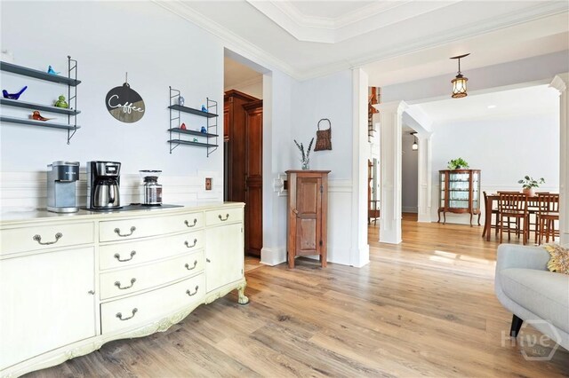 711 Chastain Cir, Richmond Hill, GA 31324 - living area featuring ornate columns, light wood finished floors, wainscoting, and ornamental molding