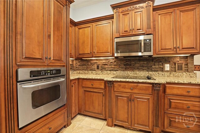 711 Chastain Cir, Richmond Hill, GA 31324 - kitchen featuring appliances with stainless steel finishes, backsplash, and light stone countertops