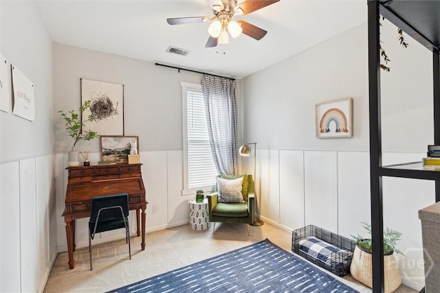 131 Tanzania Trl, Pooler, GA 31322 - living area featuring ceiling fan, a decorative wall, carpet flooring, and a wainscoted wall
