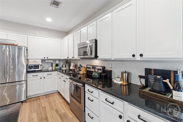 131 Tanzania Trl, Pooler, GA 31322 - kitchen featuring appliances with stainless steel finishes, white cabinetry, backsplash, and recessed lighting