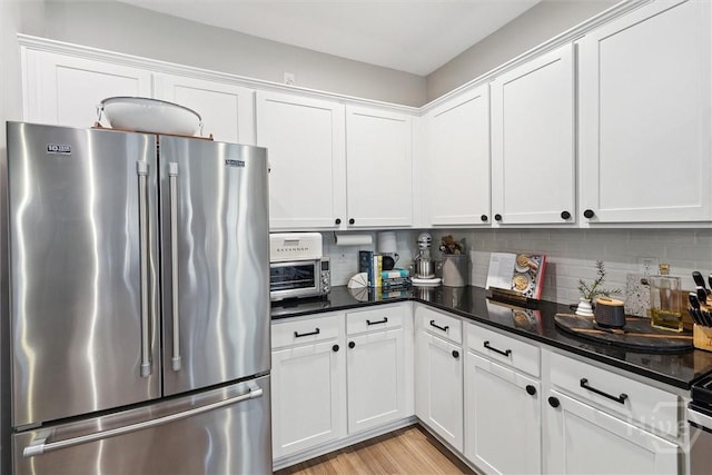 131 Tanzania Trl, Pooler, GA 31322 - kitchen with freestanding refrigerator, white cabinets, and backsplash
