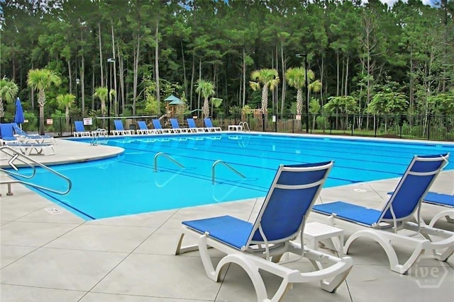 131 Tanzania Trl, Pooler, GA 31322 - community pool featuring a patio and view of wooded area