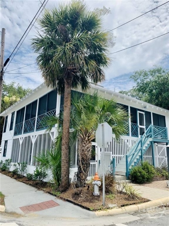 16 12th St, Tybee Island, GA 31328 - view of side of home featuring stairway and a porch