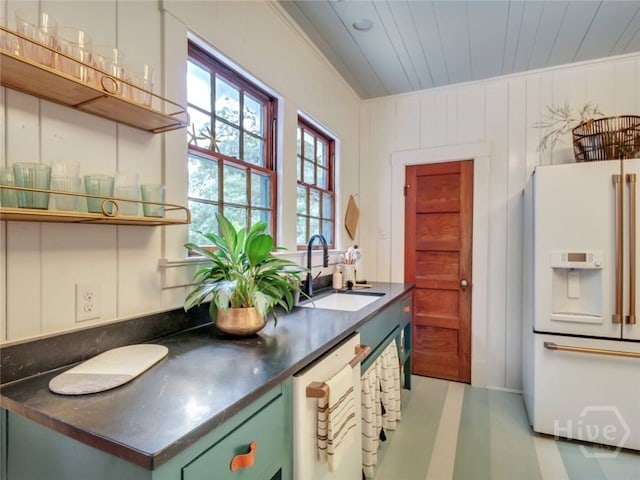 16 12th St, Tybee Island, GA 31328 - kitchen with white appliances, a sink, open shelves, dark countertops, and green cabinetry