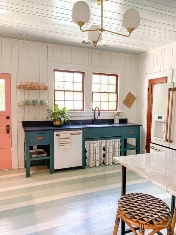 16 12th St, Tybee Island, GA 31328 - kitchen with white appliances, a sink, wood ceiling, and light wood finished floors
