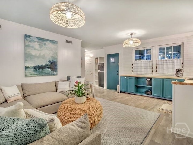 16 12th St, Tybee Island, GA 31328 - living room featuring light wood-style floors and a chandelier