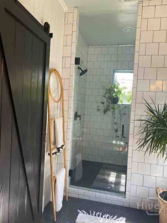 16 12th St, Tybee Island, GA 31328 - full bath featuring a shower stall and tile patterned floors