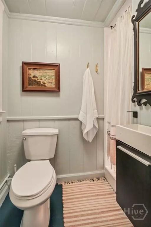 16 12th St, Tybee Island, GA 31328 - full bath featuring toilet, a stall shower, a decorative wall, vanity, and crown molding