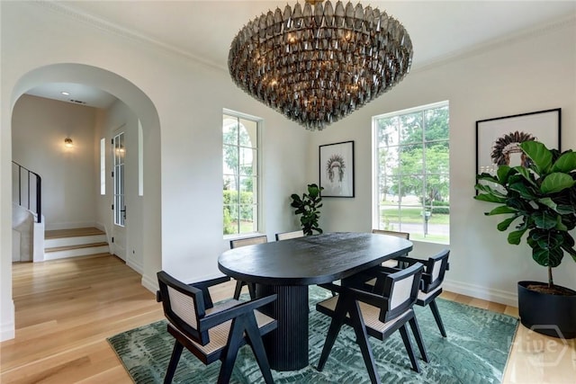 217 John Wesley Way, Savannah, GA 31404 - dining space with arched walkways, light wood finished floors, ornamental molding, stairway, and baseboards