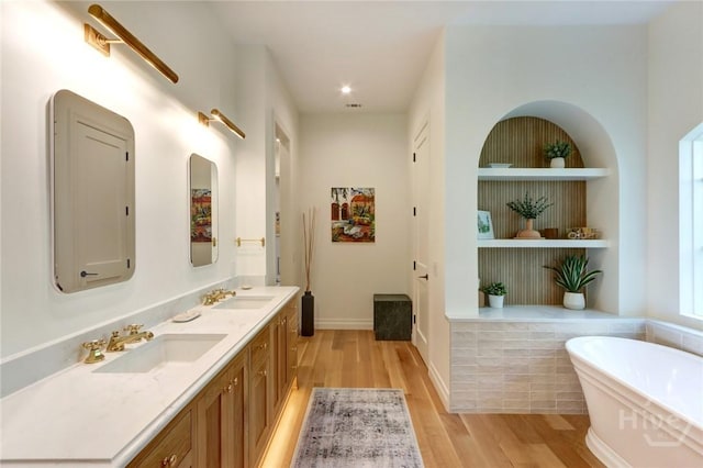 217 John Wesley Way, Savannah, GA 31404 - bathroom featuring a freestanding tub, wood finished floors, double vanity, and recessed lighting
