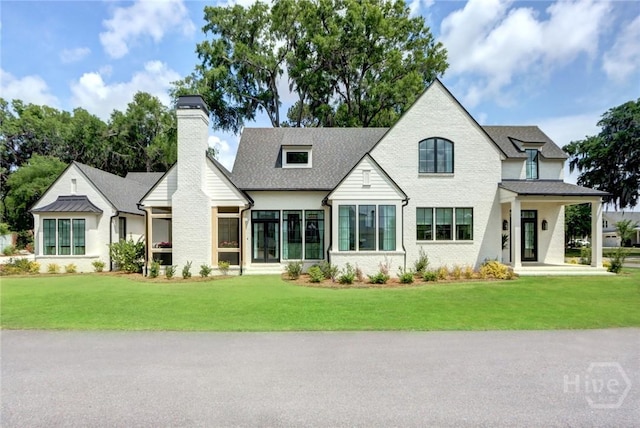 217 John Wesley Way, Savannah, GA 31404 - view of front of home featuring a chimney, a front lawn, and brick siding