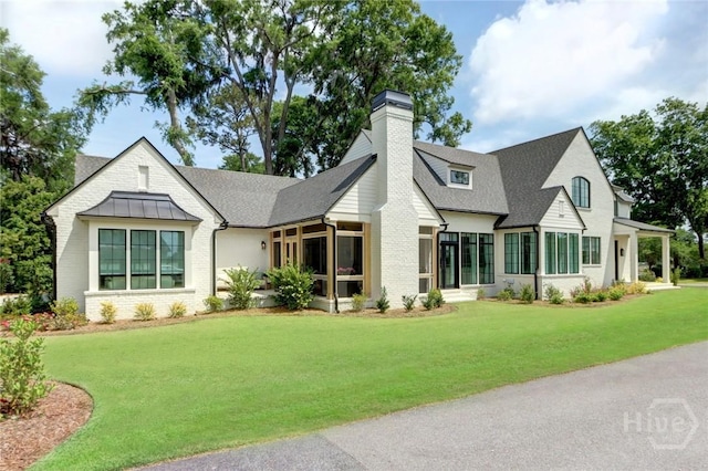 217 John Wesley Way, Savannah, GA 31404 - back of property featuring a chimney, a yard, a shingled roof, and a sunroom