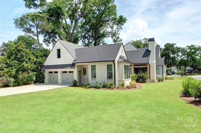 217 John Wesley Way, Savannah, GA 31404 - view of front of home featuring a chimney, driveway, a shingled roof, a front lawn, and a garage