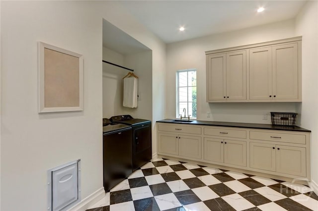217 John Wesley Way, Savannah, GA 31404 - kitchen featuring washer and dryer, a sink, dark countertops, cream cabinets, and recessed lighting