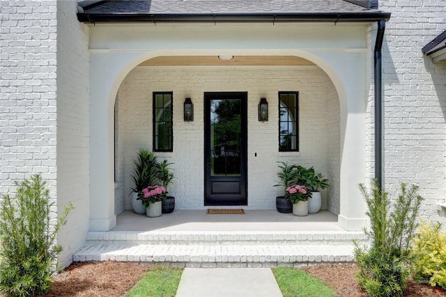 217 John Wesley Way, Savannah, GA 31404 - entrance to property with covered porch, a shingled roof, and brick siding