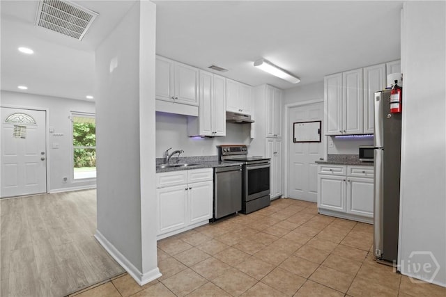 2030 E 42nd St, Savannah, GA 31404 - kitchen with stainless steel appliances, a sink, white cabinetry, under cabinet range hood, and recessed lighting