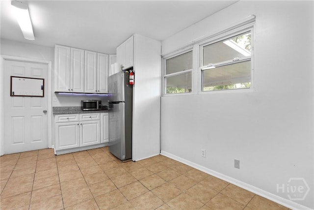 2030 E 42nd St, Savannah, GA 31404 - kitchen featuring appliances with stainless steel finishes, white cabinetry, baseboards, and light tile patterned floors