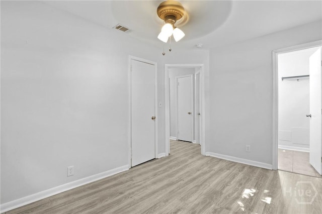 2030 E 42nd St, Savannah, GA 31404 - unfurnished bedroom featuring wood finished floors, baseboards, ensuite bath, and a ceiling fan