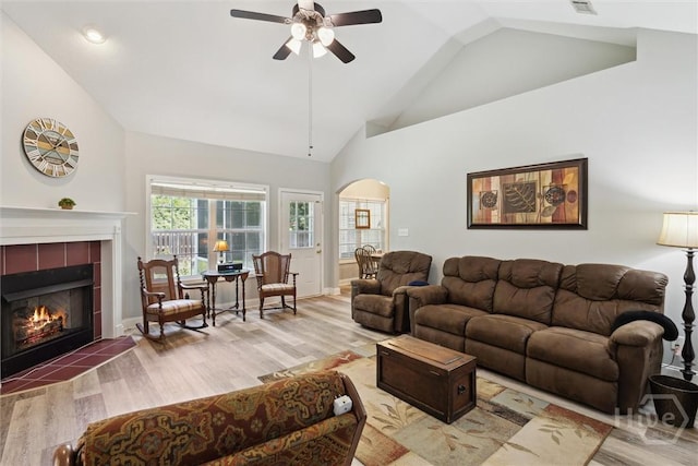 133 Cobbleton Dr, Rincon, GA 31326 - living area with arched walkways, a ceiling fan, wood finished floors, a fireplace, and high vaulted ceiling
