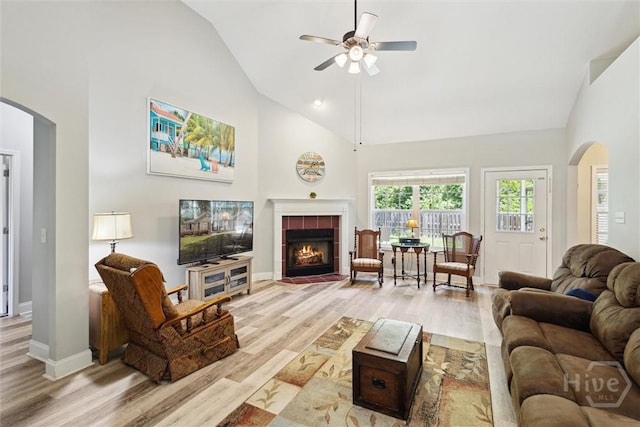 133 Cobbleton Dr, Rincon, GA 31326 - living area with arched walkways, wood finished floors, ceiling fan, a tiled fireplace, and high vaulted ceiling